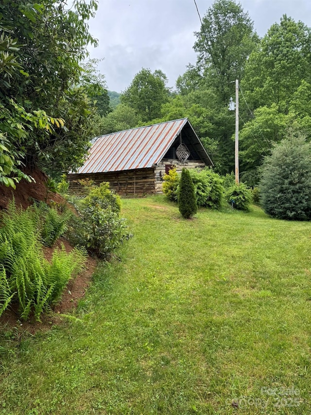 view of green lawn featuring an outdoor structure