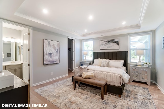 9842 Quercus Ln, Huntersville, NC 28078 - bedroom with a tray ceiling, light wood finished floors, multiple windows, connected bathroom, and crown molding