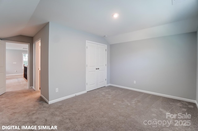 9842 Quercus Ln, Huntersville, NC 28078 - unfurnished bedroom featuring lofted ceiling, carpet, baseboards, and a closet