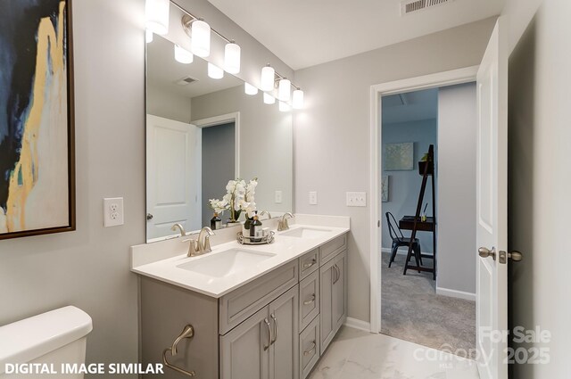 9842 Quercus Ln, Huntersville, NC 28078 - full bathroom featuring double vanity, toilet, baseboards, and marble look tiles