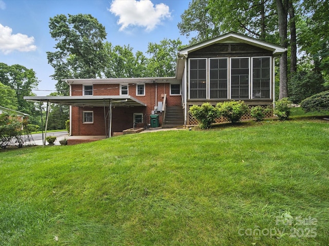 220 Lakeview Dr, Belmont, NC 28012 - back of house featuring brick siding, an attached carport, a sunroom, and a yard