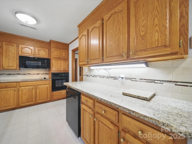 220 Lakeview Dr, Belmont, NC 28012 - kitchen featuring black appliances, tasteful backsplash, light stone counters, and brown cabinets