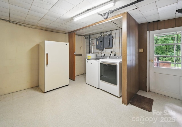 220 Lakeview Dr, Belmont, NC 28012 - laundry area featuring washer and clothes dryer, electric panel, concrete block wall, and wood walls