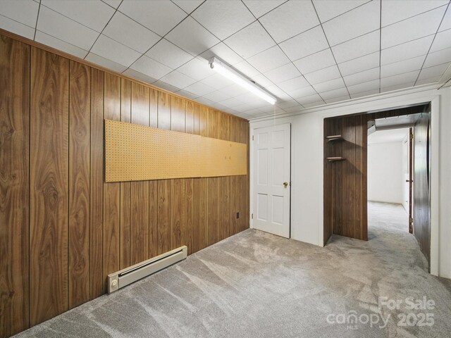 220 Lakeview Dr, Belmont, NC 28012 - unfurnished bedroom featuring a baseboard radiator, wooden walls, and carpet flooring