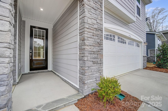 9934 Cask Way, Huntersville, NC 28078 - view of exterior entry featuring stone siding and a garage