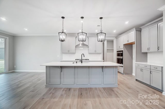 9934 Cask Way, Huntersville, NC 28078 - kitchen with gray cabinetry, light countertops, a sink, an island with sink, and crown molding