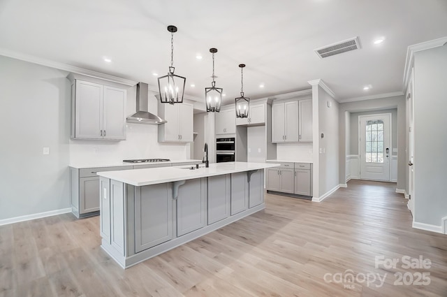 9934 Cask Way, Huntersville, NC 28078 - kitchen with wall chimney exhaust hood, gray cabinetry, ornamental molding, stovetop, and baseboards