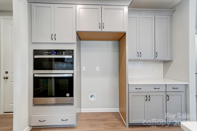9934 Cask Way, Huntersville, NC 28078 - kitchen with double wall oven, gray cabinetry, light wood-style flooring, light countertops, and baseboards