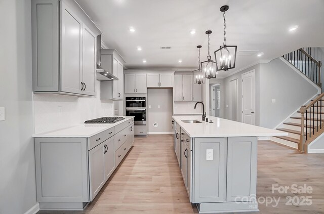 9934 Cask Way, Huntersville, NC 28078 - kitchen with light wood-style flooring, gray cabinets, gas stovetop, light countertops, and recessed lighting