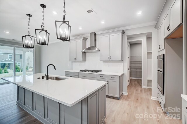 9934 Cask Way, Huntersville, NC 28078 - kitchen with wall chimney range hood, appliances with stainless steel finishes, gray cabinets, crown molding, and a chandelier