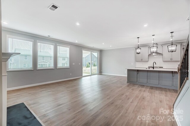 9934 Cask Way, Huntersville, NC 28078 - unfurnished living room featuring light wood-style flooring, ornamental molding, and recessed lighting