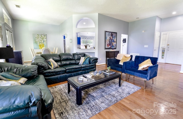 2936 Walsingham Ct, Matthews, NC 28105 - living room featuring wood finished floors, a textured ceiling, and recessed lighting