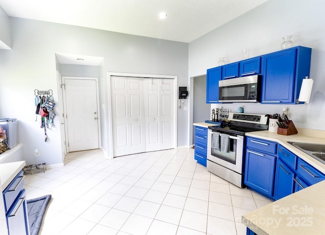 2936 Walsingham Ct, Matthews, NC 28105 - kitchen featuring stainless steel appliances, blue cabinetry, and light countertops