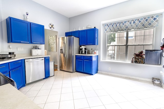 2936 Walsingham Ct, Matthews, NC 28105 - kitchen featuring stainless steel appliances, blue cabinetry, and light countertops