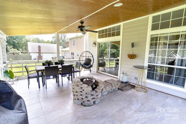 2936 Walsingham Ct, Matthews, NC 28105 - sunroom featuring outdoor dining space, ceiling fan, and a fire pit
