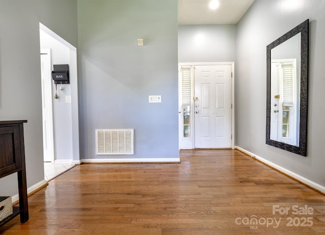 2936 Walsingham Ct, Matthews, NC 28105 - entryway featuring wood finished floors and a towering ceiling