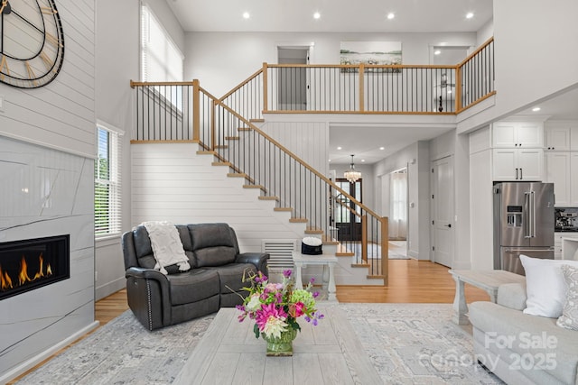 301 Rockbridge Rd Unit 22, Mills River, NC 28759 - living area with stairs, a towering ceiling, light wood-style floors, a fireplace, and recessed lighting