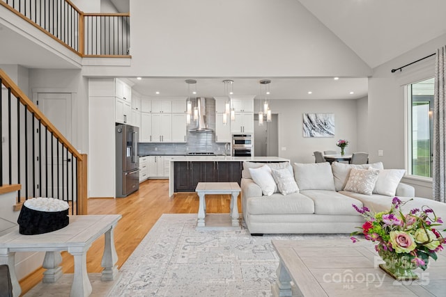 301 Rockbridge Rd Unit 22, Mills River, NC 28759 - living area featuring light wood-style floors, high vaulted ceiling, recessed lighting, and stairs