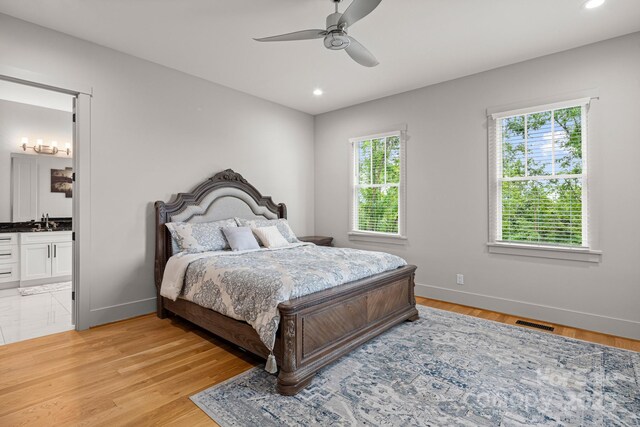 301 Rockbridge Rd Unit 22, Mills River, NC 28759 - bedroom featuring a sink, baseboards, recessed lighting, light wood finished floors, and ensuite bathroom