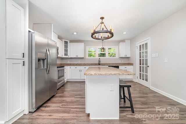 1632 Charles Raper Jonas Hwy, Mount Holly, NC 28120 - kitchen with stainless steel appliances, white cabinets, a chandelier, a kitchen bar, and recessed lighting