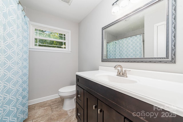 1632 Charles Raper Jonas Hwy, Mount Holly, NC 28120 - full bath with vanity, toilet, baseboards, and stone finish floors