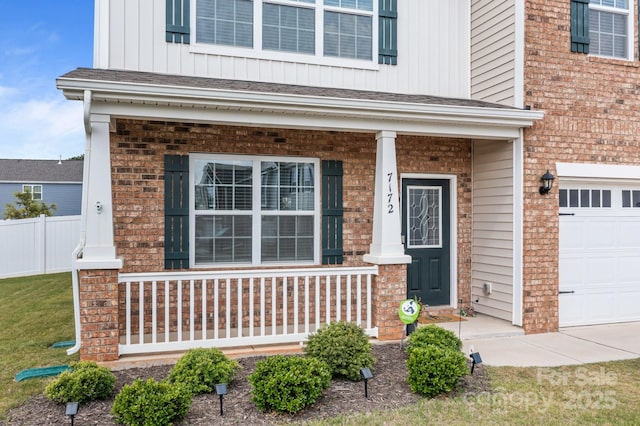 7172 Teague Dr, Gastonia, NC 28056 - property entrance featuring a porch, board and batten siding, a garage, and brick siding
