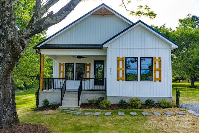 219 Grayson St, Sparta, NC 28675 - modern inspired farmhouse featuring a porch, a standing seam roof, a front lawn, and ceiling fan