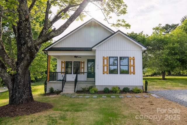 219 Grayson St, Sparta, NC 28675 - modern inspired farmhouse featuring covered porch, a ceiling fan, and a front yard