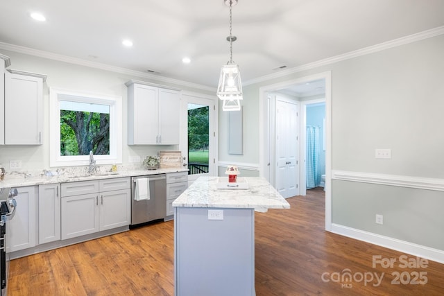 219 Grayson St, Sparta, NC 28675 - kitchen with stainless steel appliances, a center island, a sink, wood finished floors, and crown molding