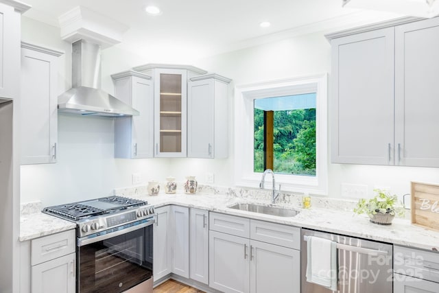 219 Grayson St, Sparta, NC 28675 - kitchen with appliances with stainless steel finishes, a sink, wall chimney range hood, ornamental molding, and glass insert cabinets