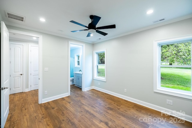 219 Grayson St, Sparta, NC 28675 - unfurnished bedroom with crown molding, multiple windows, baseboards, wood finished floors, and recessed lighting