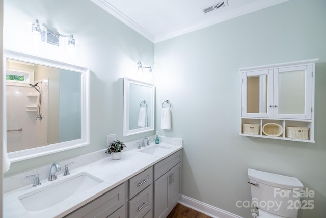 219 Grayson St, Sparta, NC 28675 - full bath with crown molding, double vanity, toilet, and baseboards