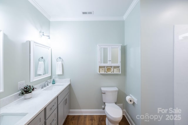 219 Grayson St, Sparta, NC 28675 - bathroom with ornamental molding, double vanity, baseboards, wood finished floors, and toilet
