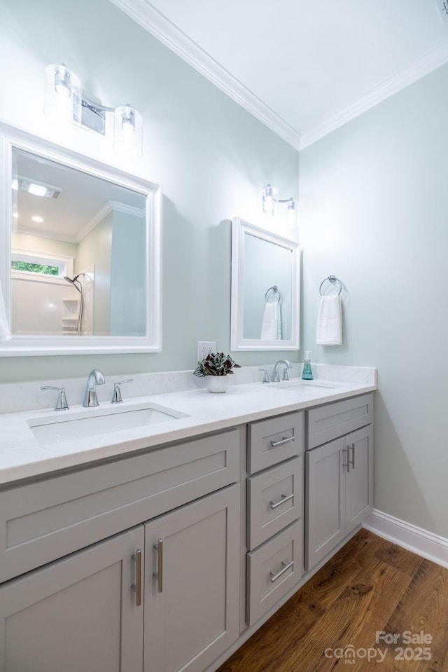 219 Grayson St, Sparta, NC 28675 - full bathroom with double vanity, ornamental molding, wood finished floors, and baseboards