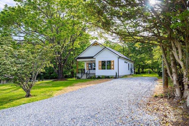 219 Grayson St, Sparta, NC 28675 - modern inspired farmhouse featuring gravel driveway, a front yard, and a porch