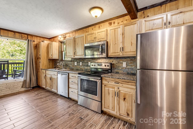 6541 Grassy Branch Rd, Bryson City, NC 28713 - kitchen with appliances with stainless steel finishes, backsplash, light brown cabinets, dark countertops, and wood walls