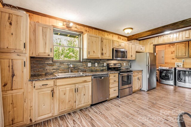 6541 Grassy Branch Rd, Bryson City, NC 28713 - kitchen featuring stainless steel appliances, washer and dryer, decorative backsplash, light brown cabinetry, and wooden walls