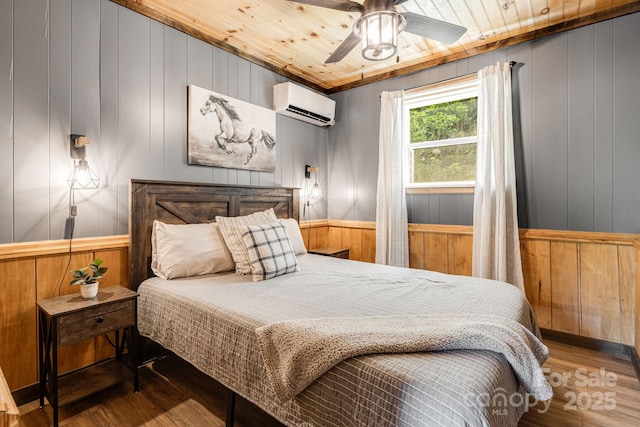 6541 Grassy Branch Rd, Bryson City, NC 28713 - bedroom featuring a wall mounted air conditioner, wood finished floors, wooden walls, wood ceiling, and ceiling fan