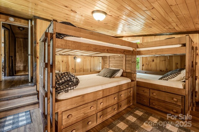 6541 Grassy Branch Rd, Bryson City, NC 28713 - bedroom featuring wood walls, wood ceiling, and dark wood-style flooring