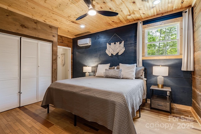 6541 Grassy Branch Rd, Bryson City, NC 28713 - bedroom with wooden ceiling, hardwood / wood-style floors, an AC wall unit, wood walls, and a closet