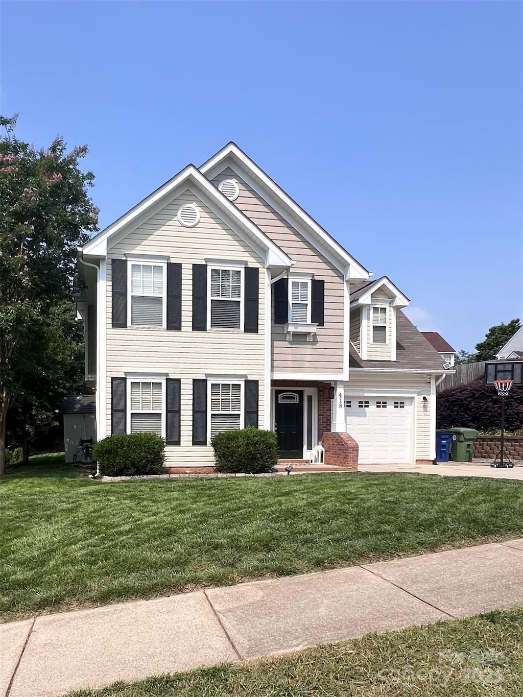 418 Eastway Ln SW, Conover, NC 28613 - view of front of home with a front yard, driveway, and an attached garage