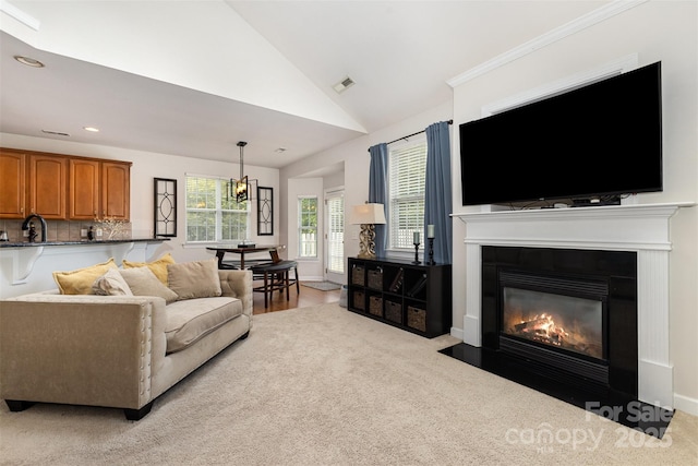9814 Tompkins Ln, Waxhaw, NC 28173 - living room featuring lofted ceiling, recessed lighting, a fireplace with flush hearth, and light carpet