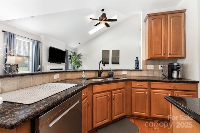 9814 Tompkins Ln, Waxhaw, NC 28173 - kitchen featuring a sink, a ceiling fan, stainless steel dishwasher, backsplash, and vaulted ceiling