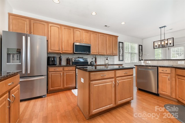 9814 Tompkins Ln, Waxhaw, NC 28173 - kitchen with appliances with stainless steel finishes, light wood finished floors, decorative backsplash, a chandelier, and recessed lighting