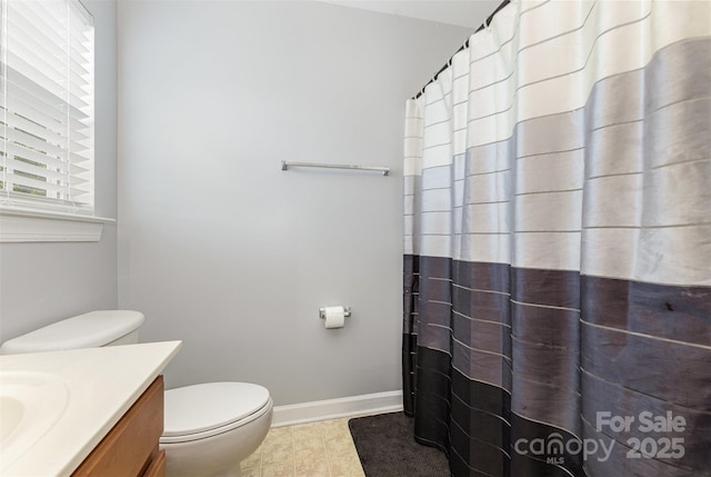 9814 Tompkins Ln, Waxhaw, NC 28173 - bathroom with vanity, toilet, baseboards, curtained shower, and tile patterned flooring