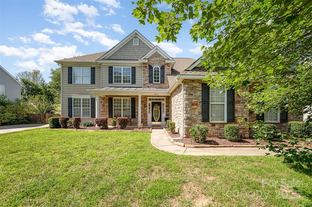 9814 Tompkins Ln, Waxhaw, NC 28173 - view of front of home with stone siding, covered porch, a front yard, and a standing seam roof
