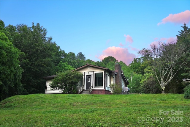 825 Pole Miller Ext, Brevard, NC 28712 - view of front of home featuring entry steps, a yard, and a chimney