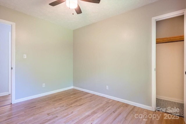 825 Pole Miller Ext, Brevard, NC 28712 - unfurnished bedroom with light wood finished floors, baseboards, a closet, and a ceiling fan