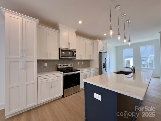 6013 Countess Dr Unit 51, Charlotte, NC 28217 - kitchen with stainless steel appliances, light wood-type flooring, white cabinets, tasteful backsplash, and recessed lighting
