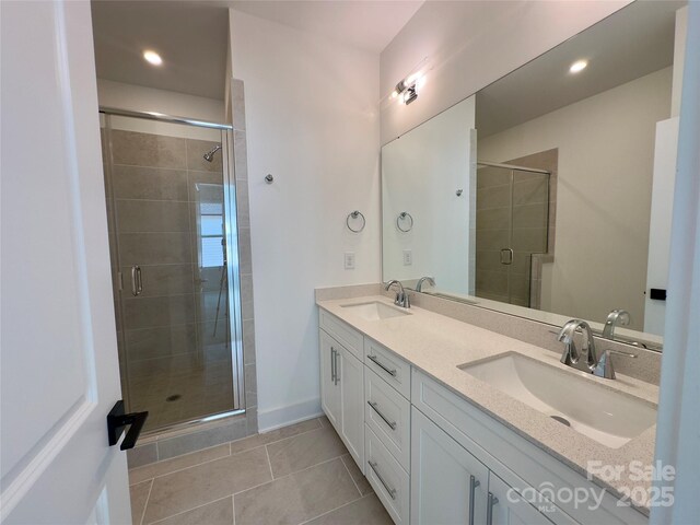 6013 Countess Dr Unit 51, Charlotte, NC 28217 - bathroom featuring double vanity, a stall shower, tile patterned floors, recessed lighting, and baseboards